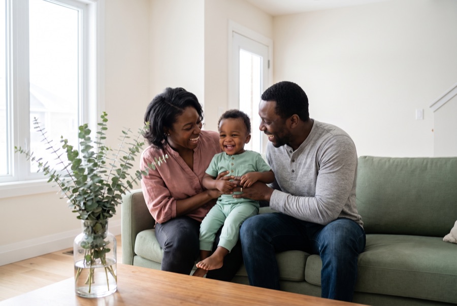 Parents laughing with their toddler at home